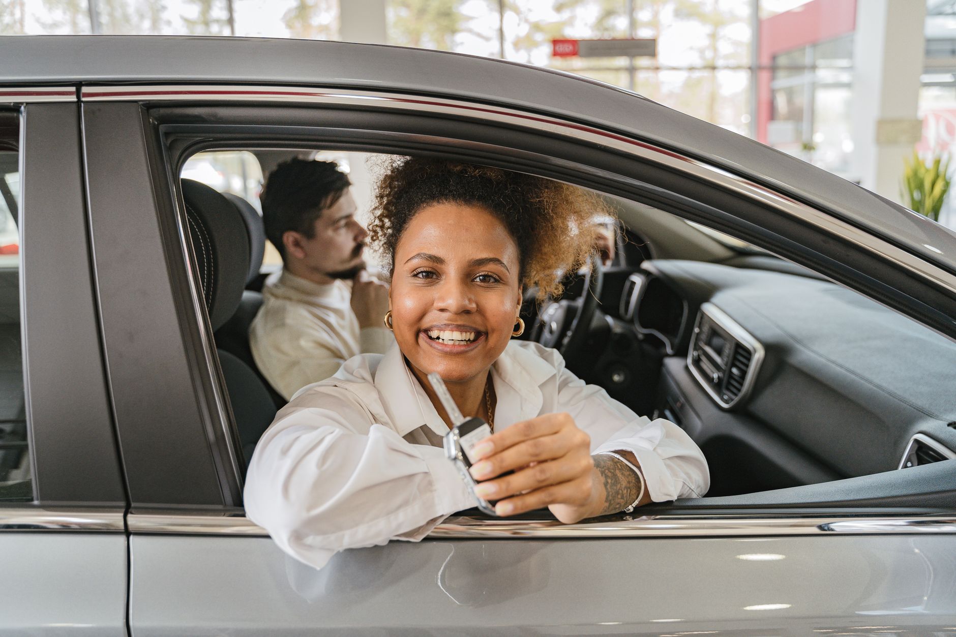 Keys being handed over for a first car, the moment the real costs actually start