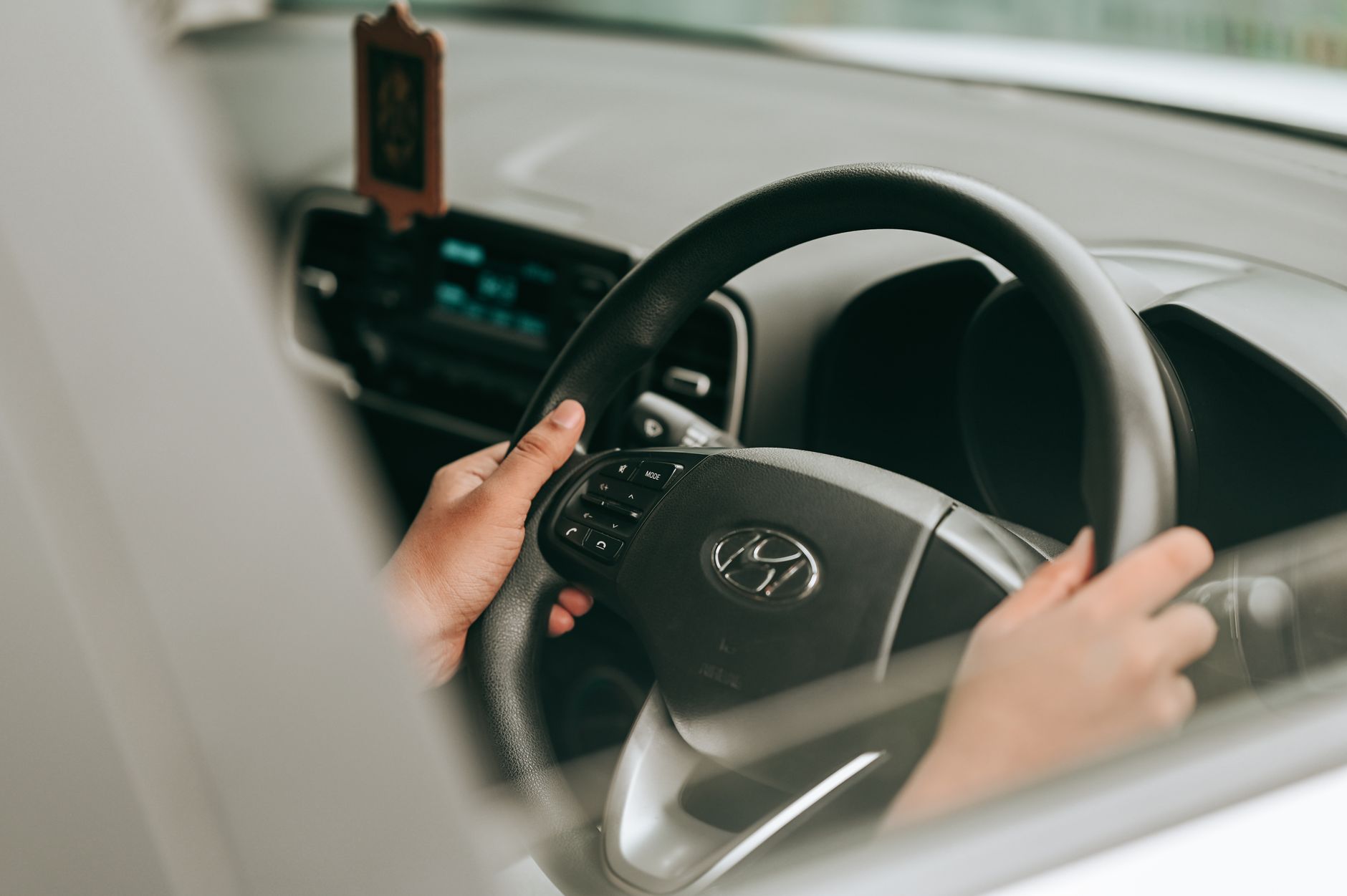 Hands placed correctly on the steering wheel, the kind of settled control the pre-test work is meant to make automatic
