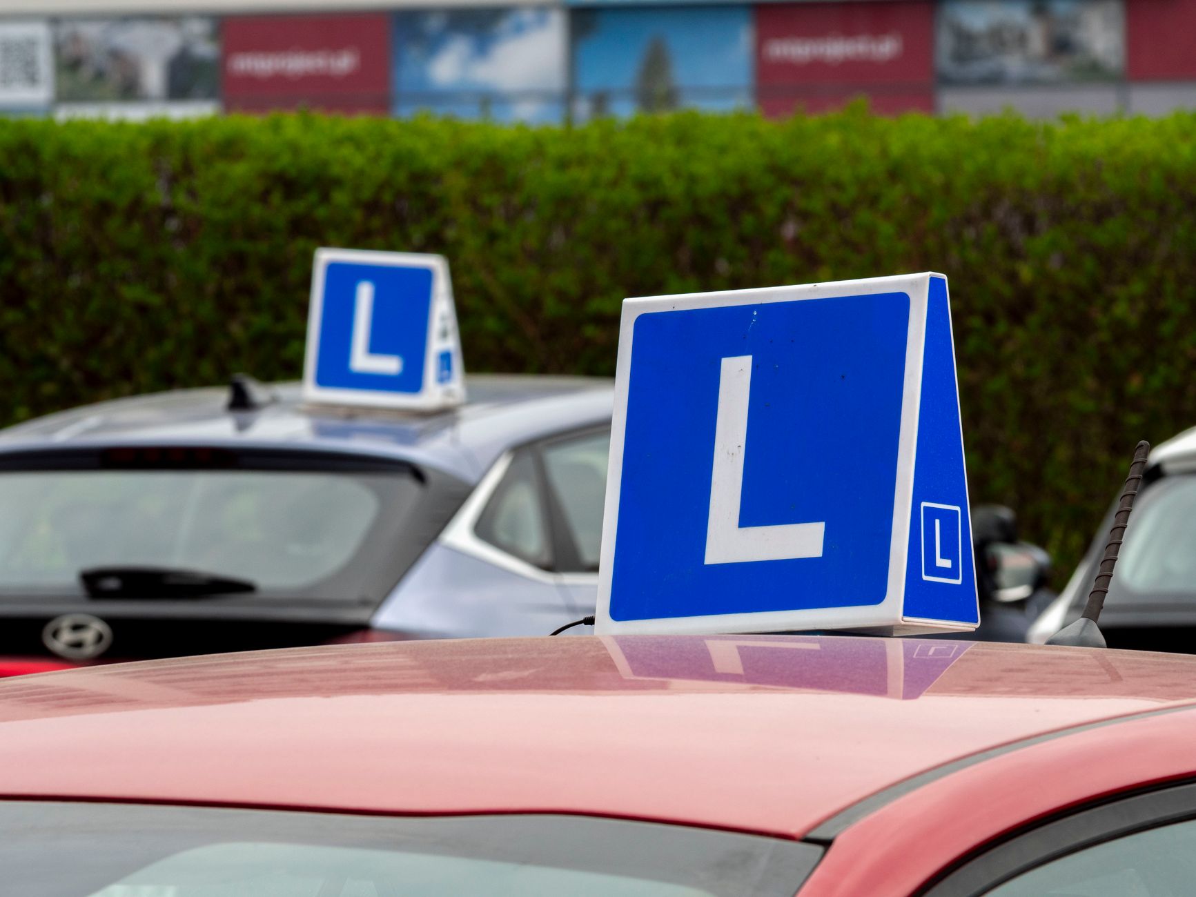 A driving-school car with learner plates on a Cork road, where the habits that outlast the test are actually built